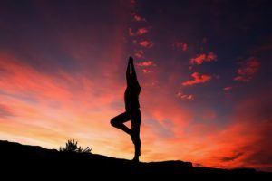 lady doing yoga in sunset