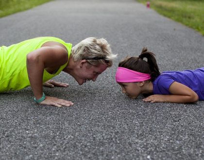 mom and her daughter doing push-ups