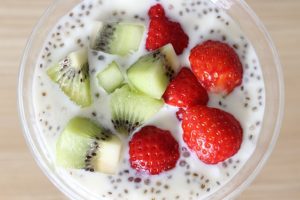 strawberries and kiwi in a bowl with dairy