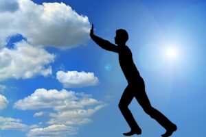 image of man pushing clouds to the left